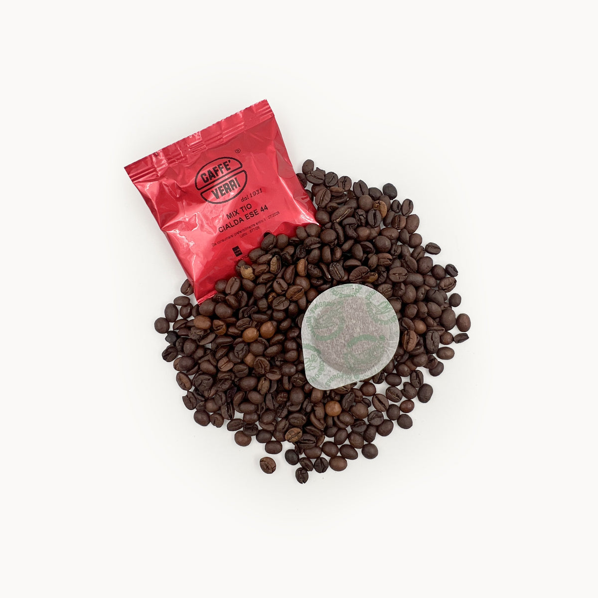Caffè Verri ESE 44 pod sachet and paper pod on roasted Tiomoka coffee beans
